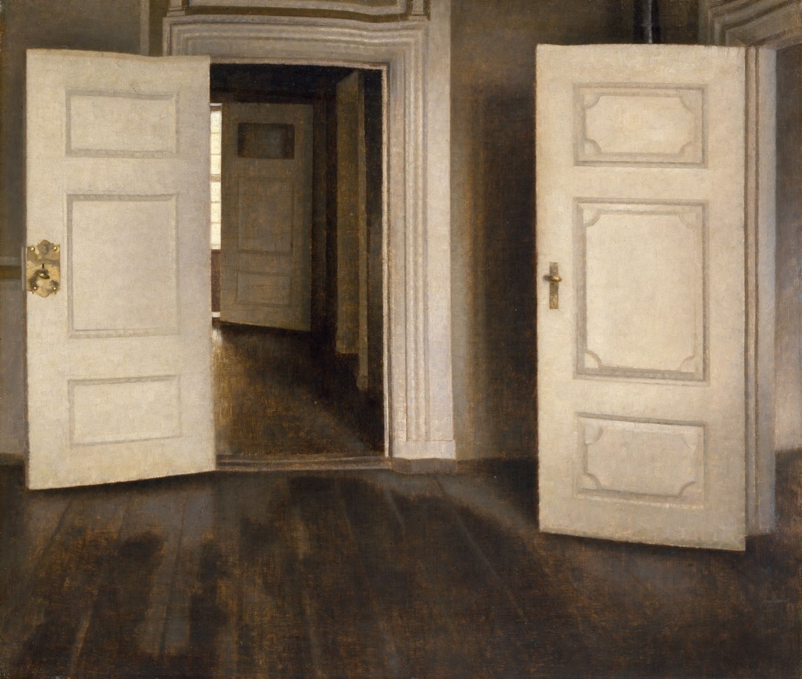 A spare, pale interior with a sequence of open white doors receding into empty sunlit rooms.