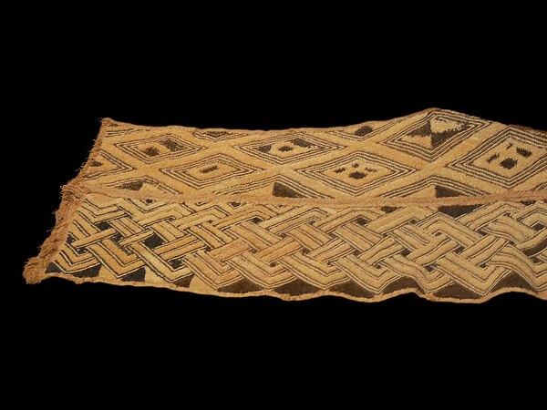 Close-up of Kuba embroidered velvet raffia cloth from the Democratic Republic of Congo, showing intricate geometric patterns.