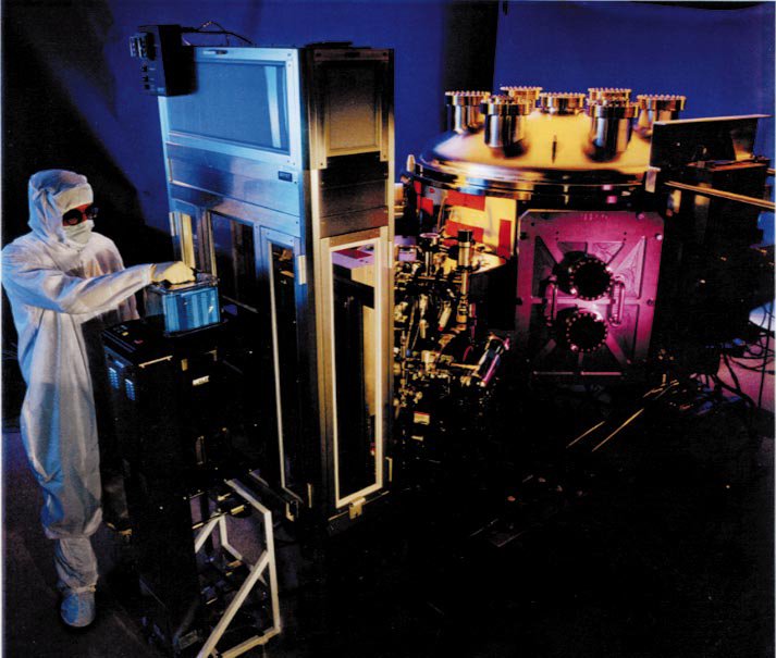 The interior of an ASML EUV lithography tool, a complex stack of vacuum chambers, optics, and silver cladding.