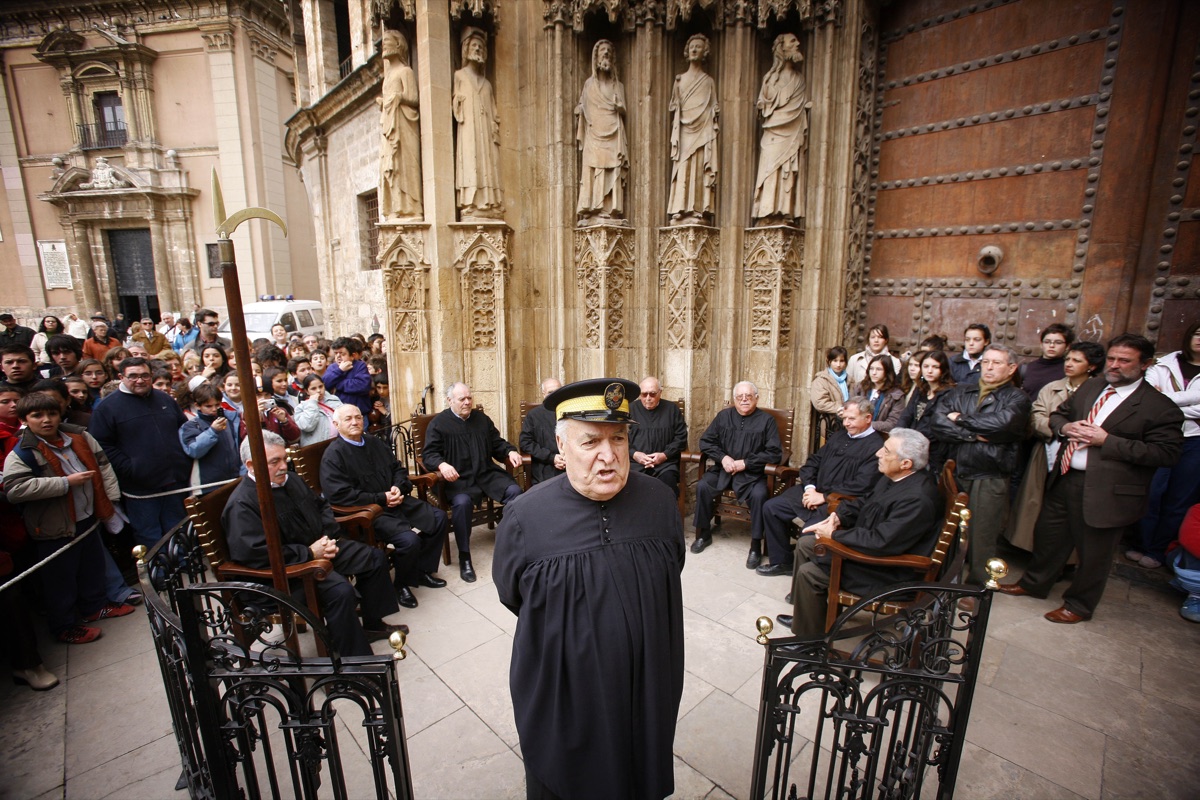 Eight elected farmer-judges in session at the thousand-year-old Water Tribunal of Valencia, outside the cathedral’s Door of the Apostles.