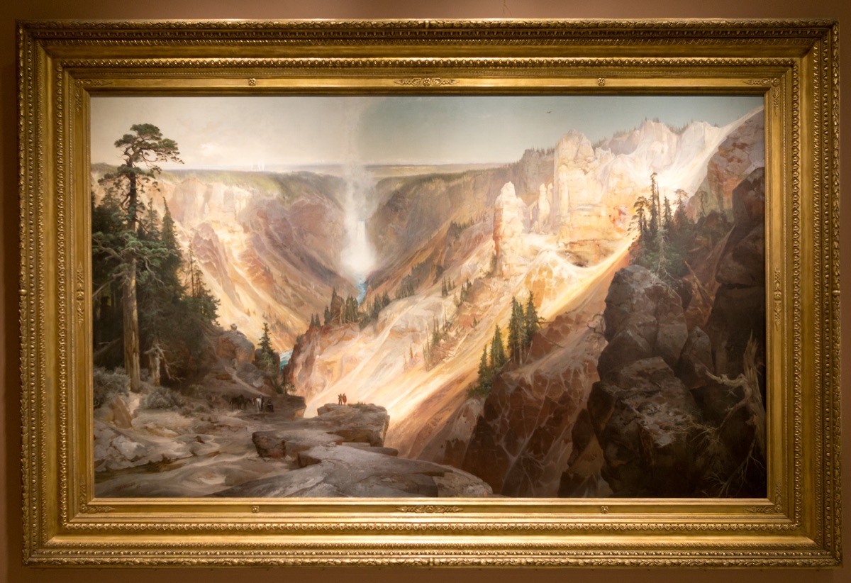 A vast western canyon plunging away from the viewer toward a distant waterfall, painted in the year Yellowstone became a national park.