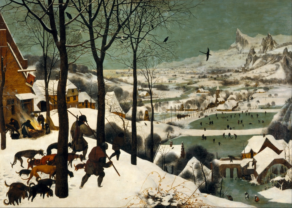 A line of hunters with dogs trudging through deep snow on a hill above a frozen Flemish village.